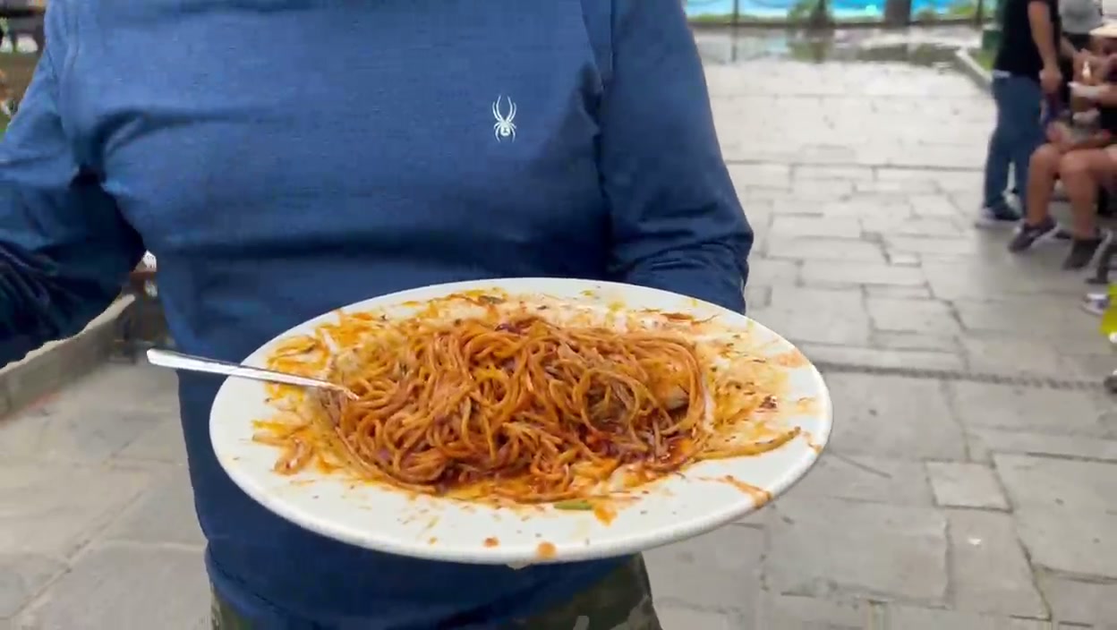 Plato de tallarines servido en una feria gastronómica al aire libre